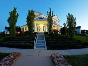Grand colonial-style residence featuring a prominent portico entrance with substantial columns