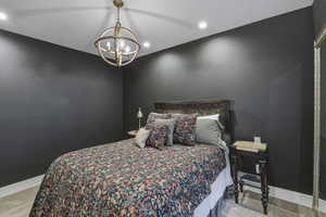 Bedroom featuring dark gray walls, white trim, and light gray carpeting