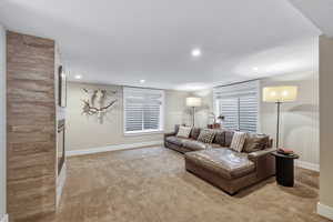 Spacious room featuring broadloom carpet, recessed lighting, and two egress windows with blinds