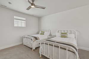 Room featuring light-toned carpeting, a window with blinds, and white walls