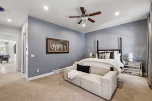 Carpeted bedroom with recessed lighting, ceiling fan, and a four-poster bed frame