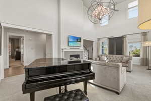 Grand living area featuring a double-height ceiling and multiple windows