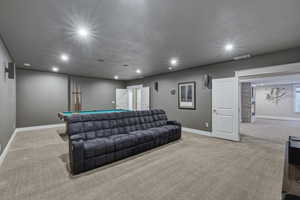 Spacious recreation room featuring recessed lighting, gray wall tones, and neutral carpeting