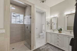Walk-in shower with full-height tile surround and glass enclosure