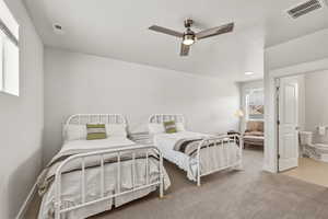 Spacious room featuring light-colored carpeting, a ceiling fan with integrated lighting, and white walls