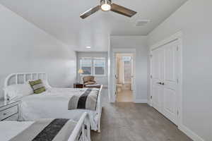 Spacious bedroom featuring light neutral wall paint, recessed lighting, and a ceiling fan
