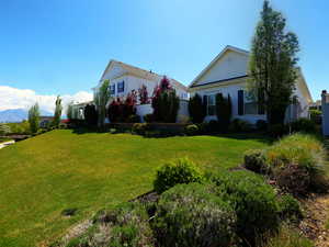 Expansive green lawn with established landscaping and mature trees