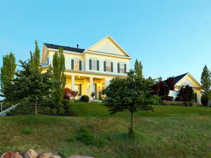 Two-story residential structure with a covered front porch and traditional gabled architecture