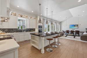 Open concept kitchen and dining area featuring light wood-finish flooring