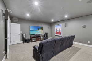 Carpeted room featuring recessed lighting and integrated wall speakers