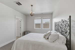 Recessed windows with blinds providing natural light, complemented by a decorative chandelier