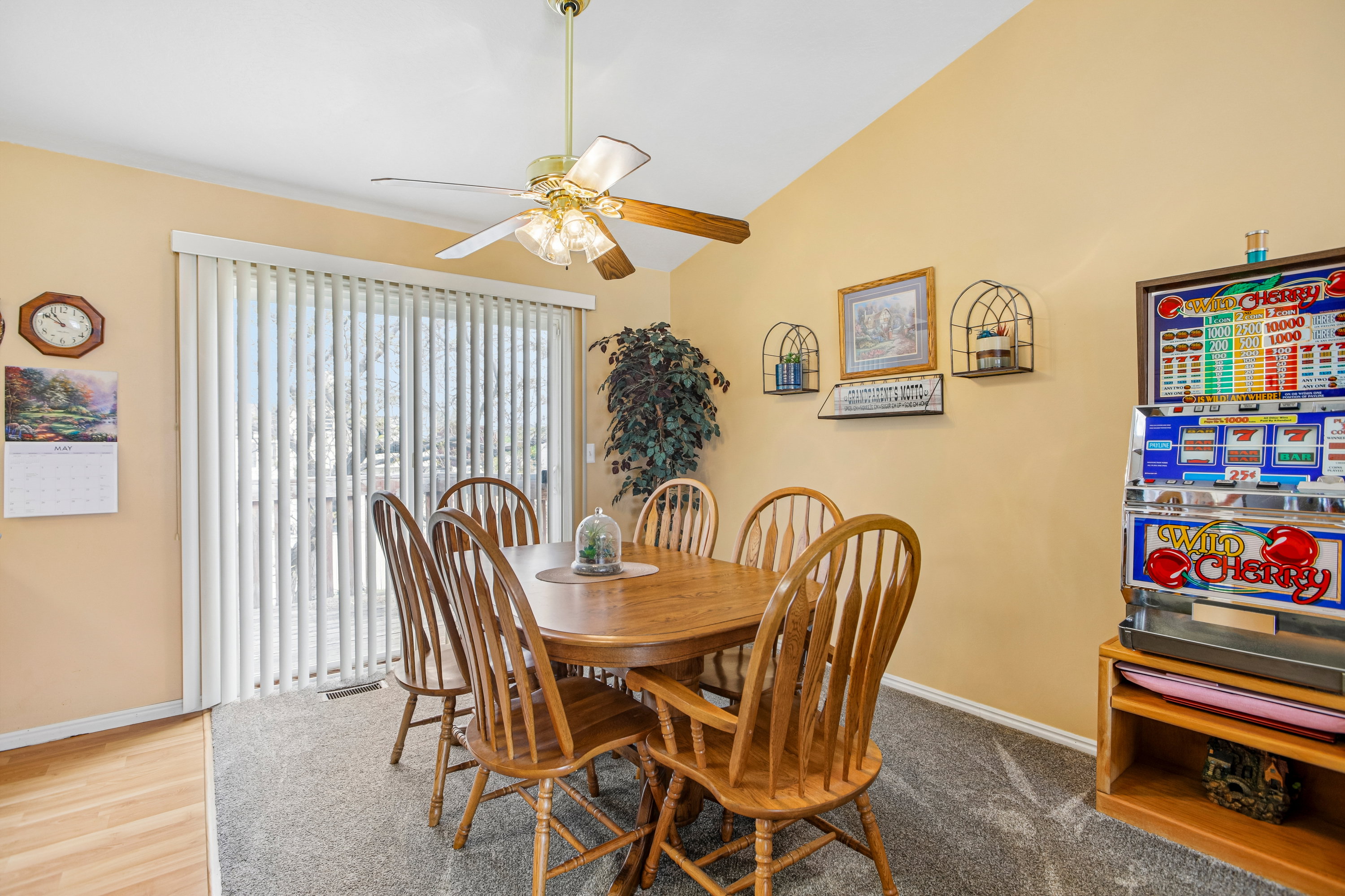 Dining area featuring a vaulted ceiling and a ceiling fan with light fixture