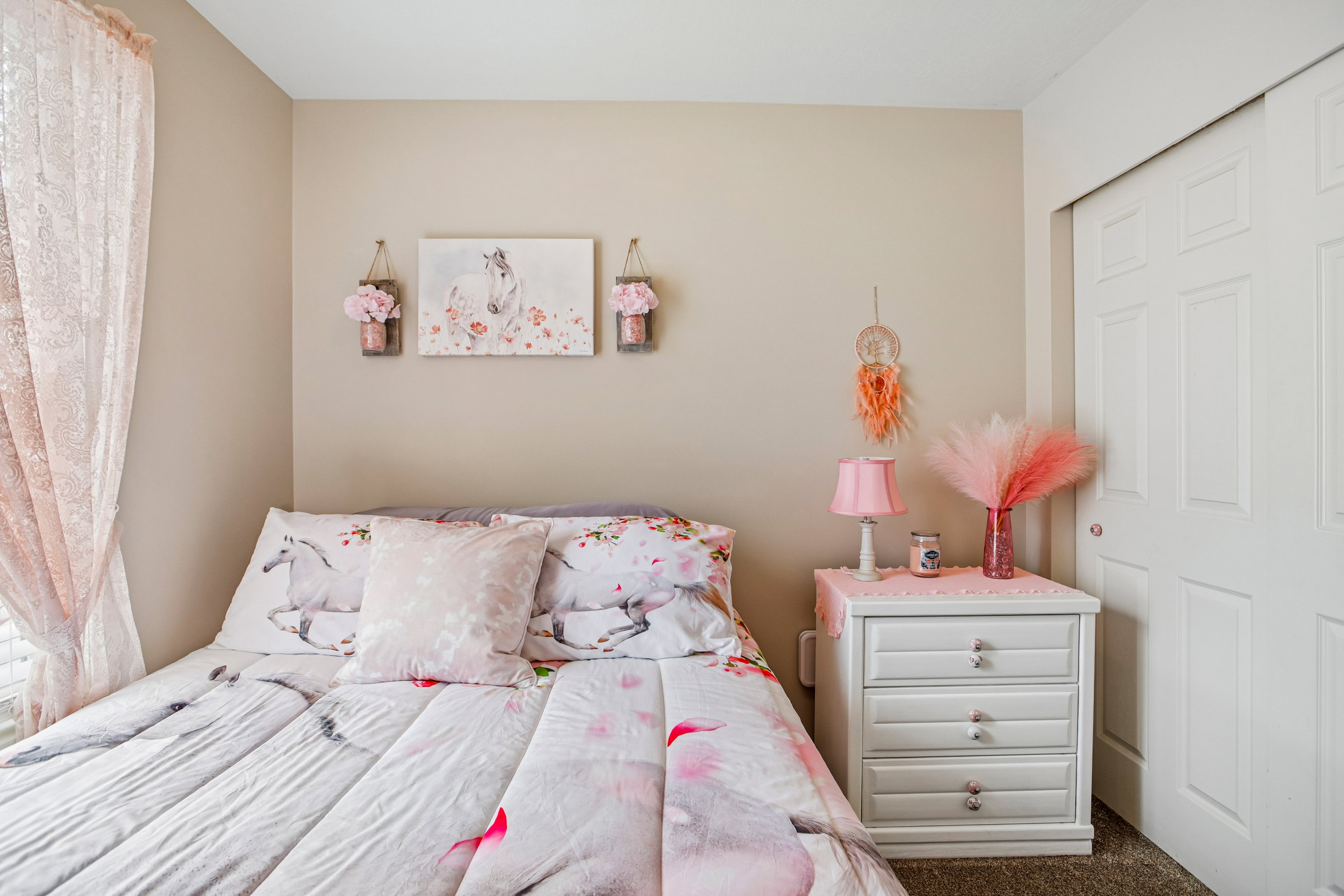 Neutral-toned walls complement the white bifold closet doors