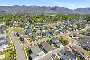 Expansive suburban neighborhood featuring a variety of architectural styles, mature trees, and paved streets