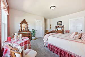 Spacious room featuring neutral wall paint and grey carpeting