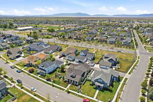 Expansive aerial perspective of a residential street featuring uniform sidewalks and mature street trees