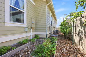 Exterior siding in a light sage hue with white trim