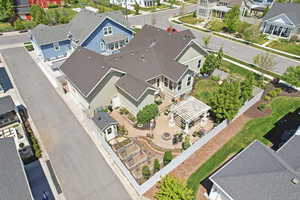 Expansive paved patio featuring a white pergola and a fire pit