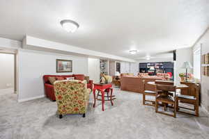 Spacious lower-level room featuring light gray carpeting and recessed lighting