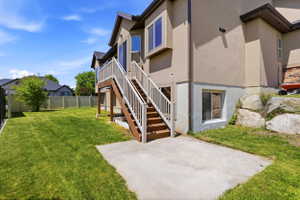 Spacious backyard featuring a manicured lawn, full fencing, and mature trees