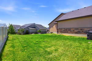 Expansive green lawn with a vinyl privacy fence