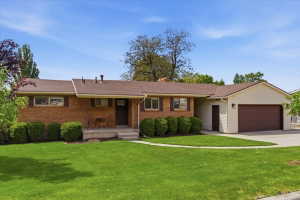 Brick exterior with a brown shingle roof