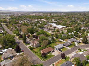 Expansive aerial perspective showcasing a neighborhood with mature trees and residential properties