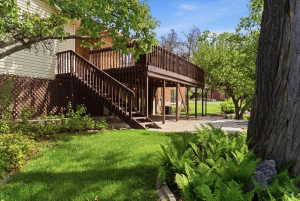 Multi-level deck with sturdy railings and stairs, providing access to the yard