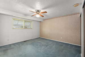 Room featuring blue carpeting, a ceiling fan with light fixture, and a window with horizontal blinds