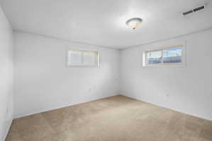 Neutral-toned carpet flooring complementing white walls