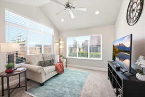 Living room with ceiling fan, light colored carpet, and recessed lighting