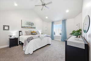 Bedroom featuring light colored carpet, ceiling fan, vaulted ceiling, and recessed lighting
