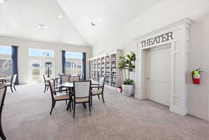 Dining room featuring light carpet, vaulted ceiling, and recessed lighting