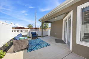 Fenced backyard with a patio area and an outdoor hangout area