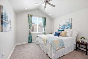Bedroom featuring light carpet and a ceiling fan