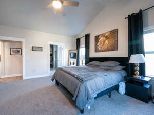 Bedroom featuring a vaulted ceiling with a ceiling fan, light gray carpet, and white trim