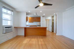 Open-concept living space with wood-finish flooring