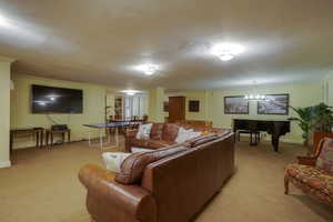 Spacious finished room featuring textured ceilings, recessed lighting, and wall-to-wall carpeting