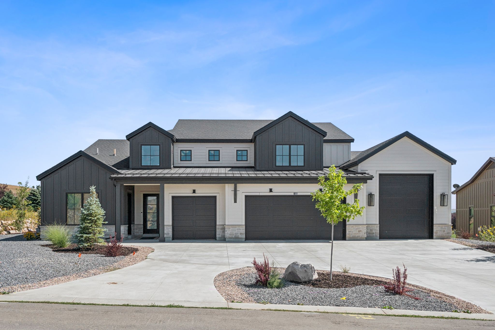 Modern farmhouse exterior with extra large 4-car garage with RV/boat parking.