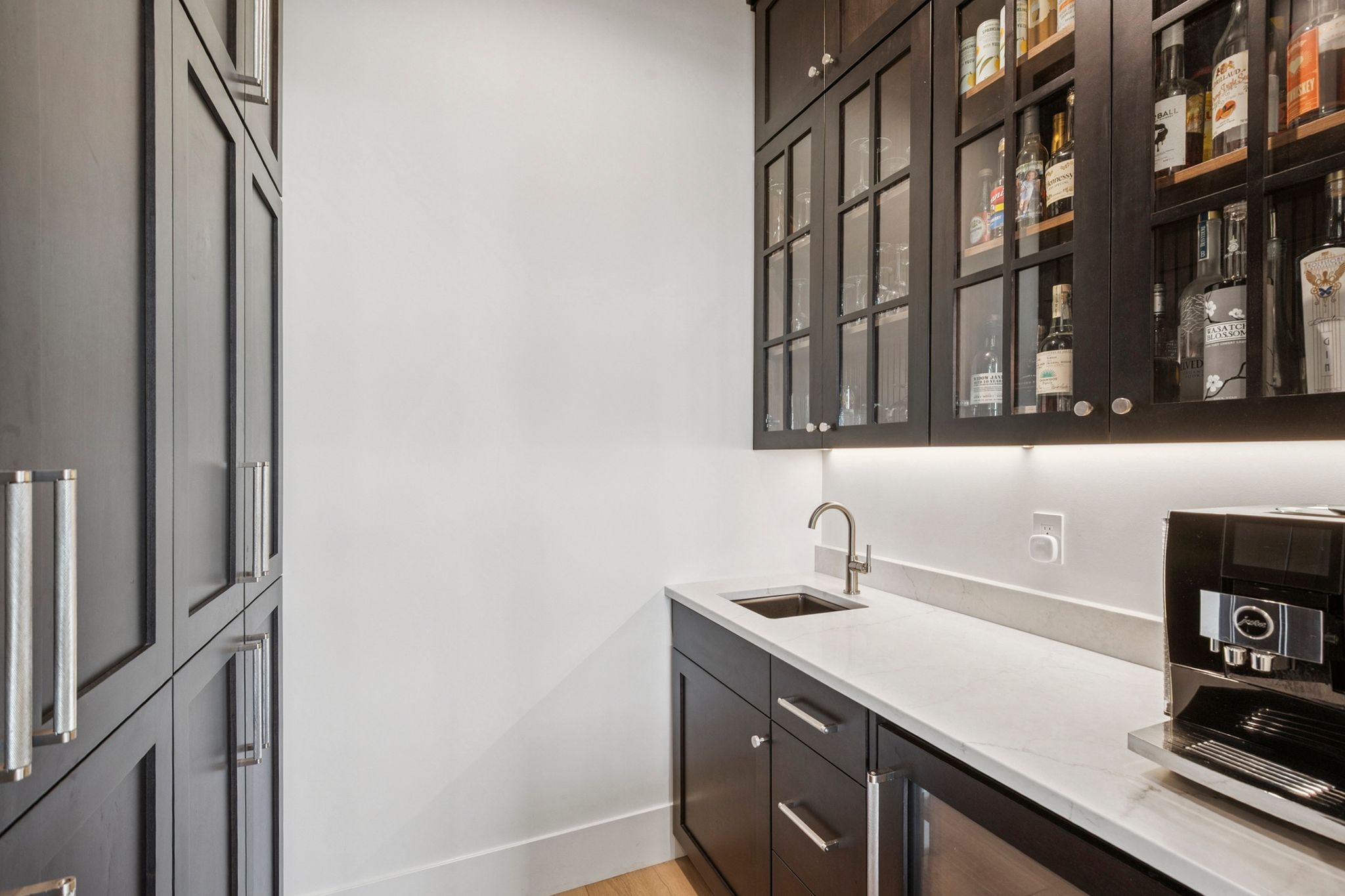 Custom wet bar/beverage station plus large pantry with pull-out shelves.