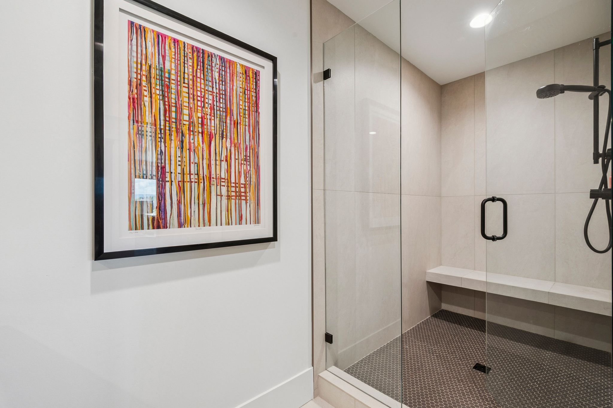 Second primary suite with large walk-in shower featuring a frameless glass enclosure,