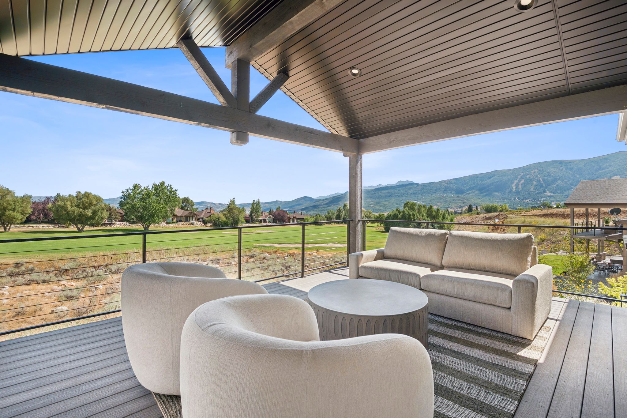 Spacious covered deck overlooking golf course and the Wasatch range, Snowbasin, Nordic Valley,and Pineview Reservoir,