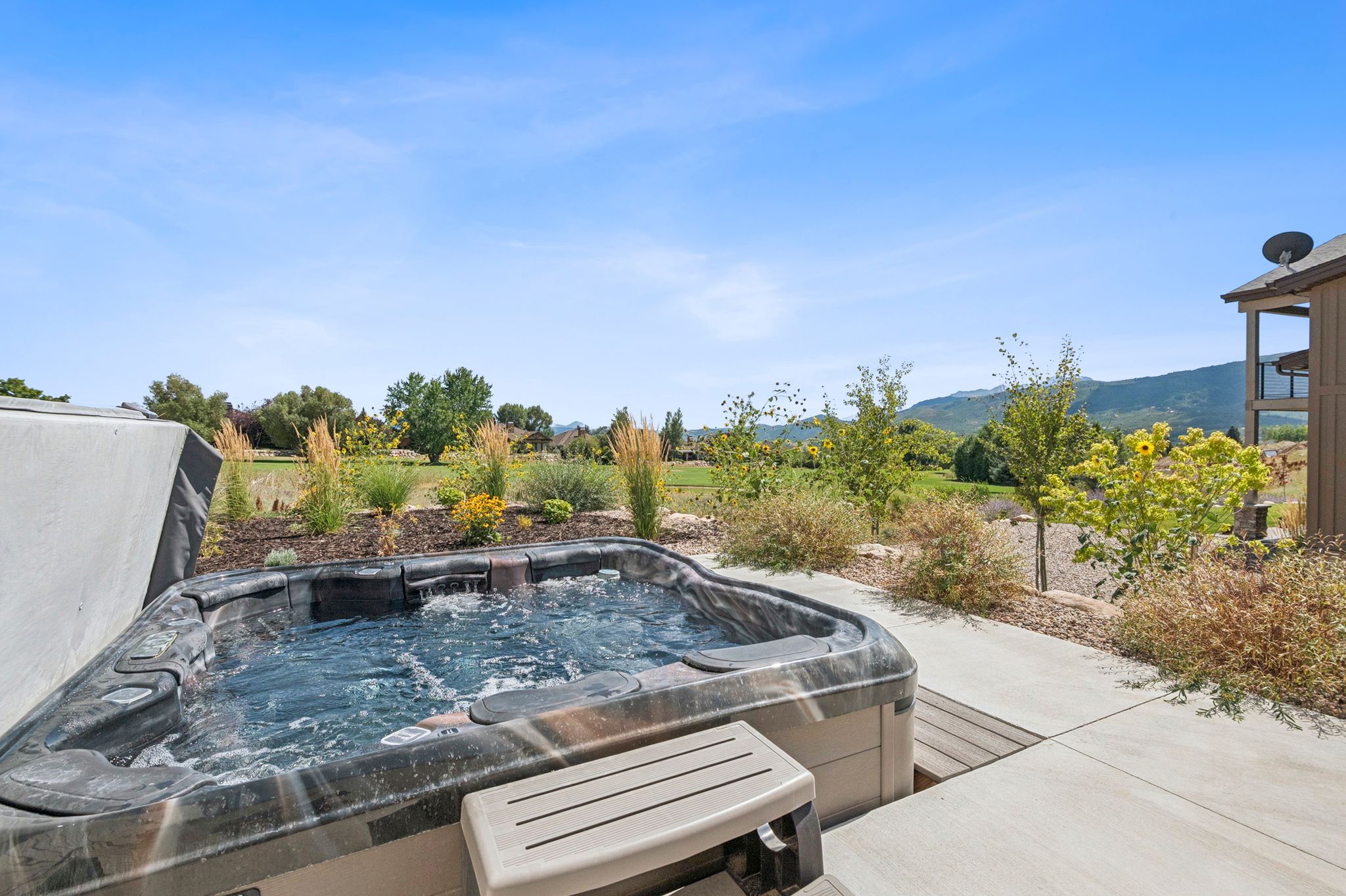 Outdoor in-ground hot tub with stunning views.