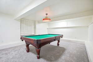 Spacious room featuring light gray carpeting, crisp white walls, and a recessed ceiling