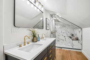 Dual vanity with integrated rectangular sinks and brass-finish fixtures