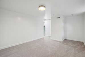 Neutral tone carpeting and white walls in this interior space