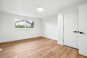 Light wood-finish flooring complements crisp white walls and modern trim