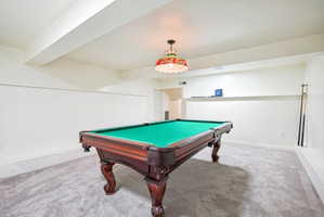 Finished room featuring recessed lighting, a built-in display shelf, and light gray carpeting