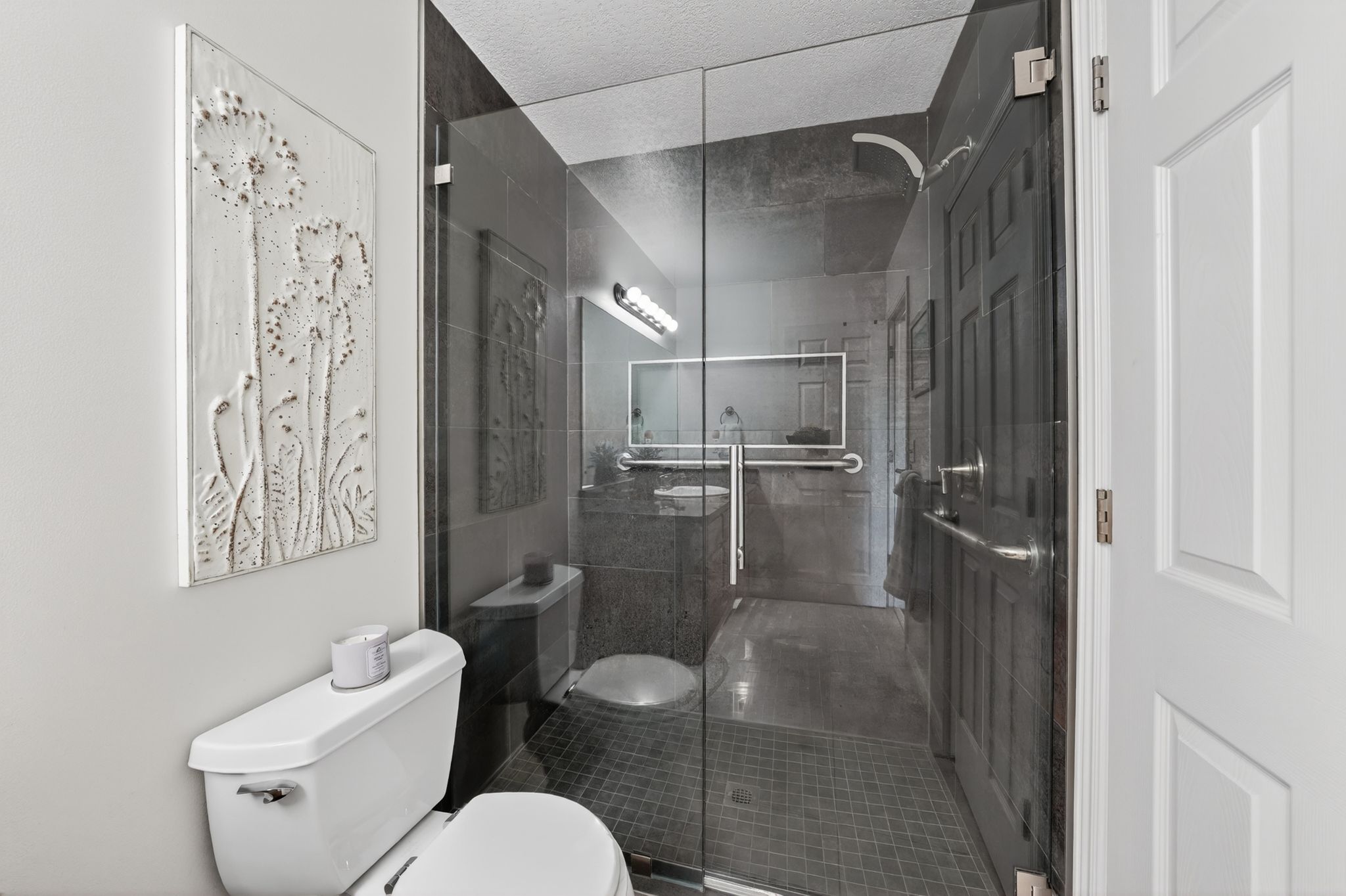 Bathroom featuring toilet and a stall shower