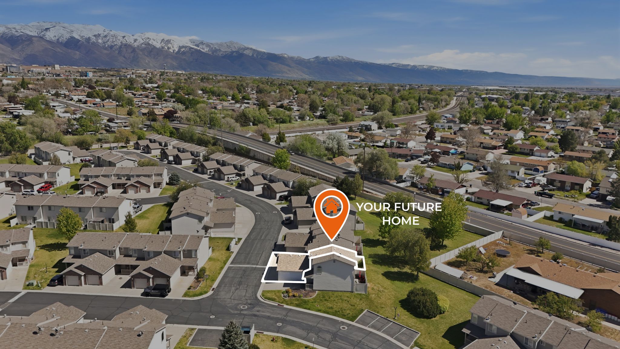 Aerial overview of property's location with nearby suburban area and mountains
